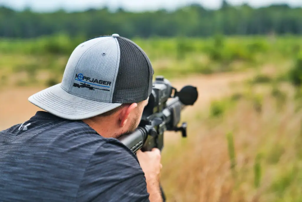 person wearing hat shooting in an open area