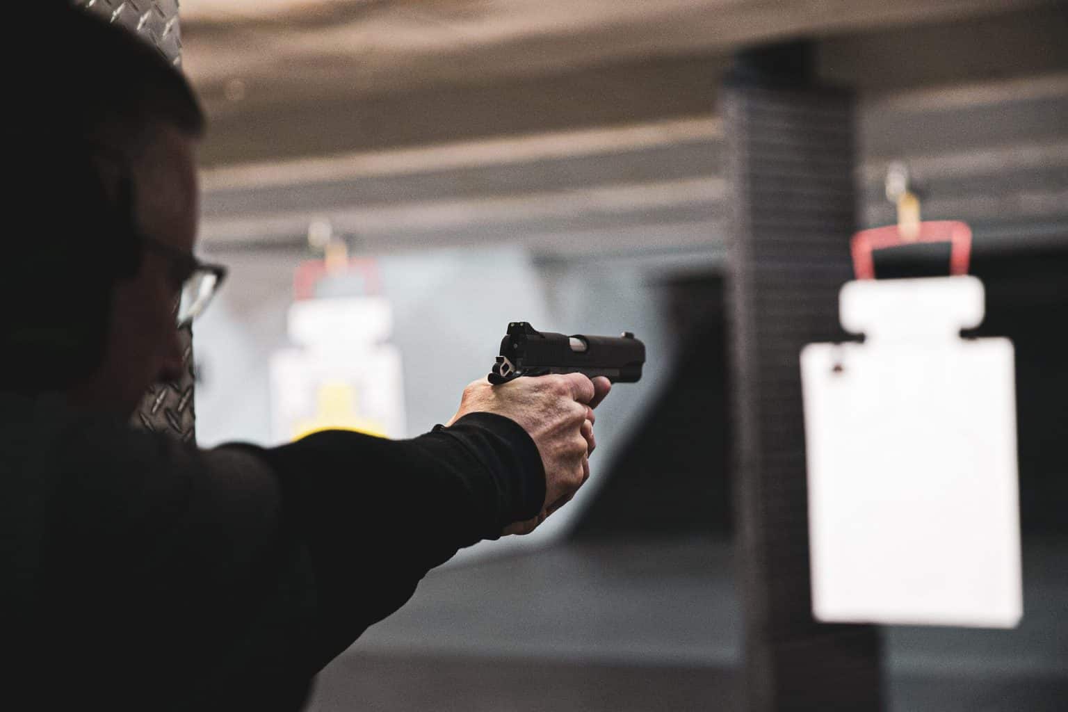 A guy doing a practice shooting with a pistol