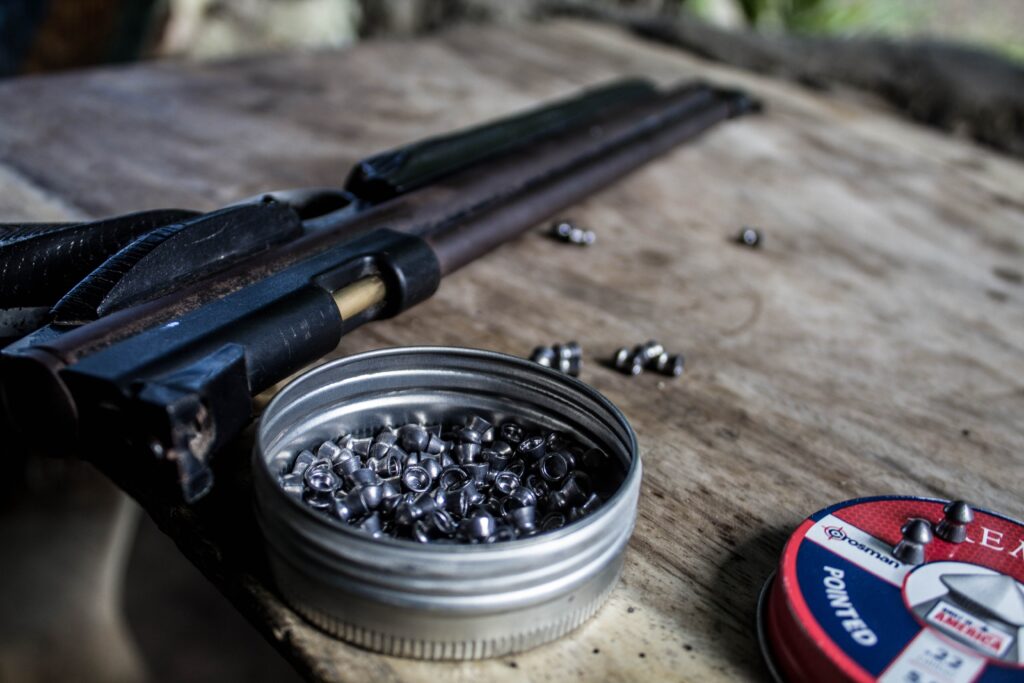 Rifle and bullets on wooden table