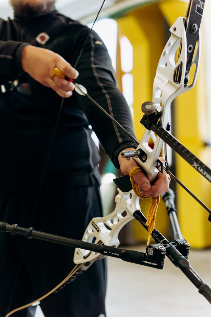 Man adjusting his Hoyt bow