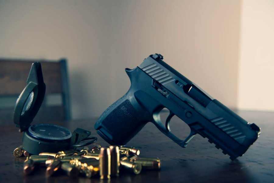 Handgun with bullets surrounding it