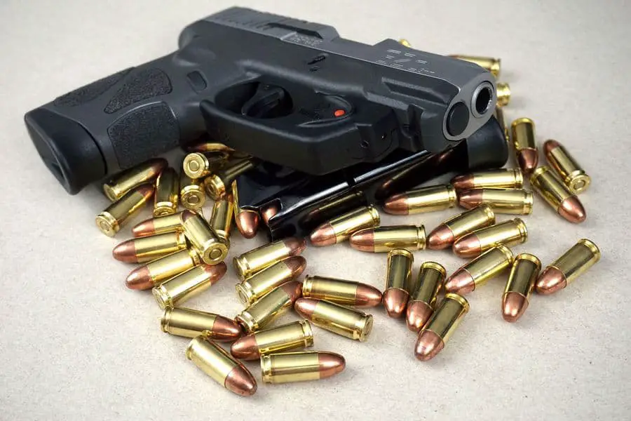 Handgun with bullets surrounding it