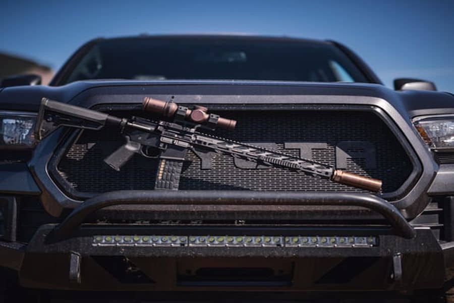 Rifle placed in front of a car