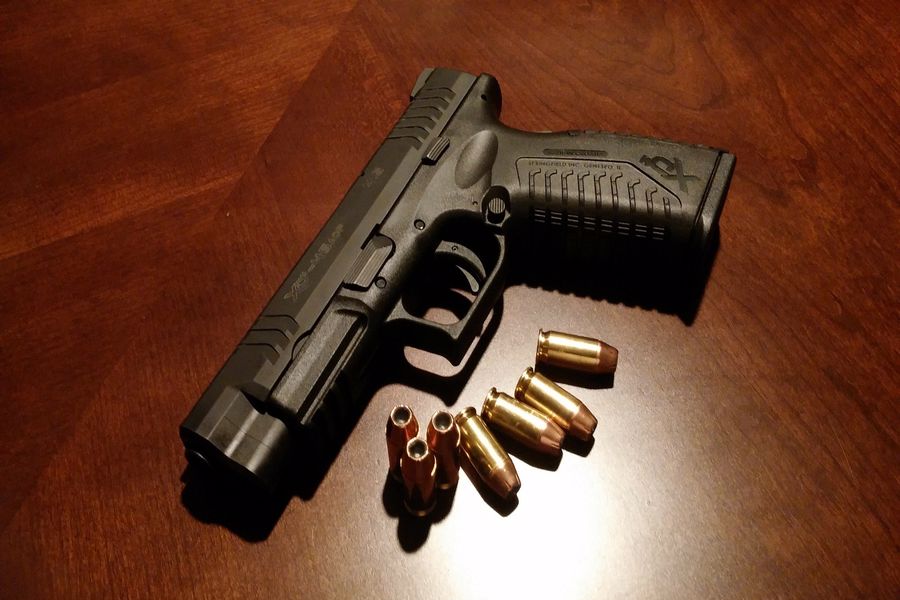 Handgun with bullets surrounding it