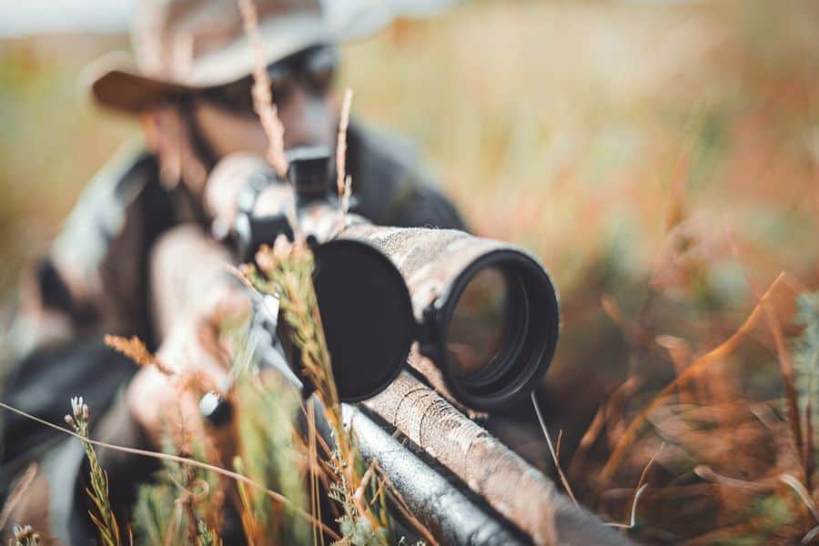 Close up of a rifle with a mounted scope