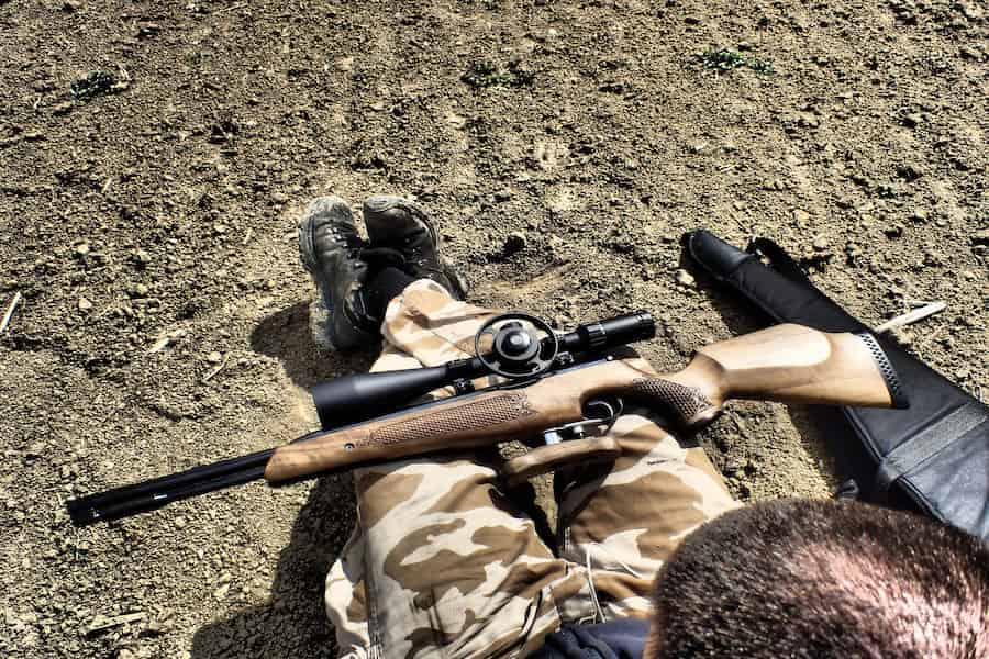 An air gun placed on top of a man's lap