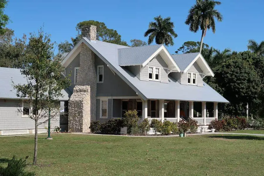 A gray and white home with a big lawn