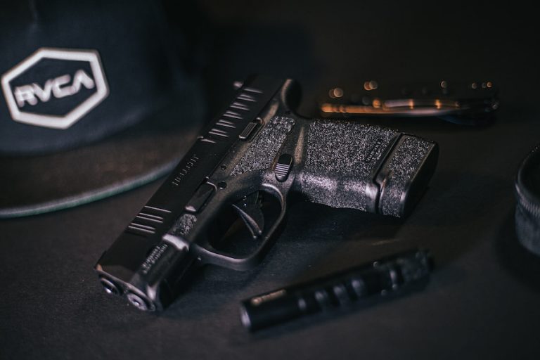 A photo of a handgun with grip tape