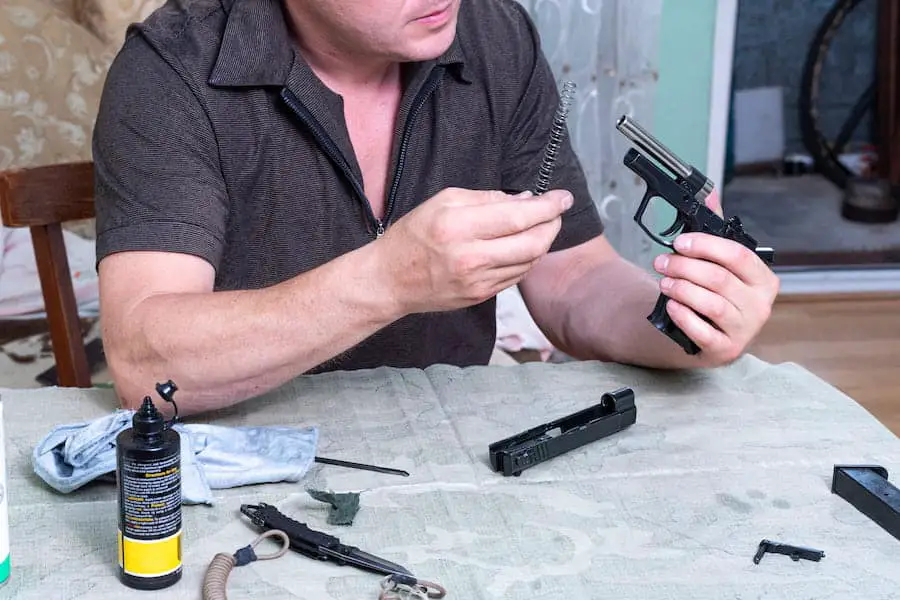A man using gun oil to clean his gun