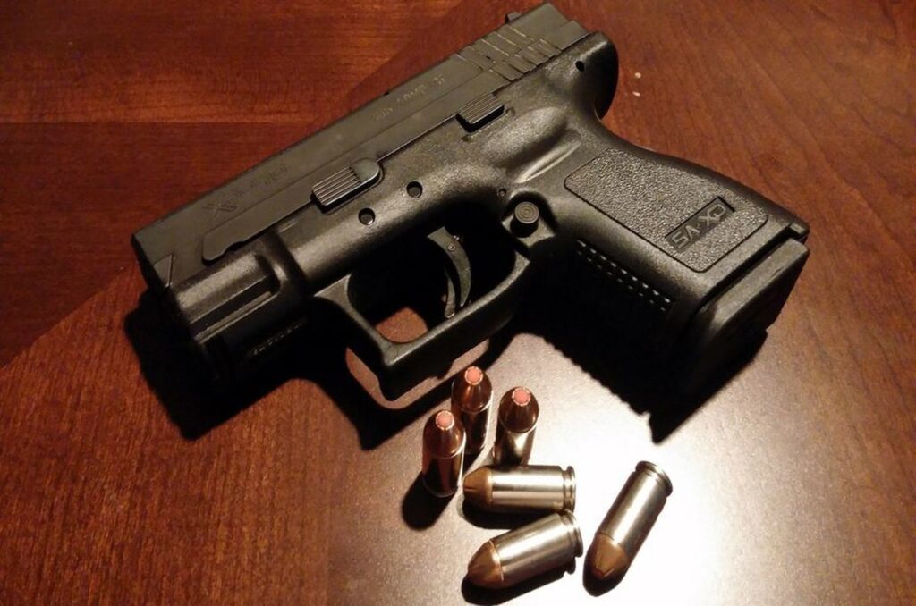 40 Cal pistol with bullets beside it