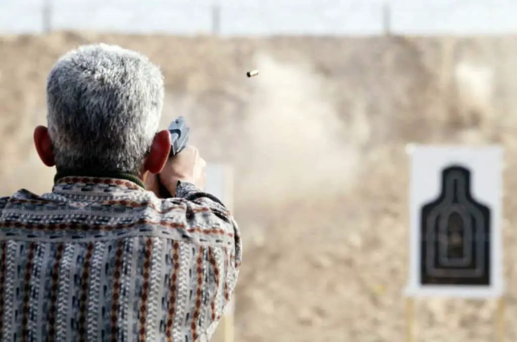 Man practicing his gun shooting skills at a gun range