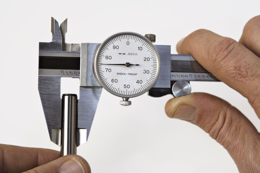 Person using a dial caliper