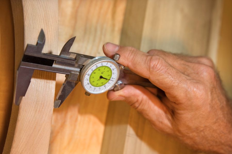 Person using a dial caliper